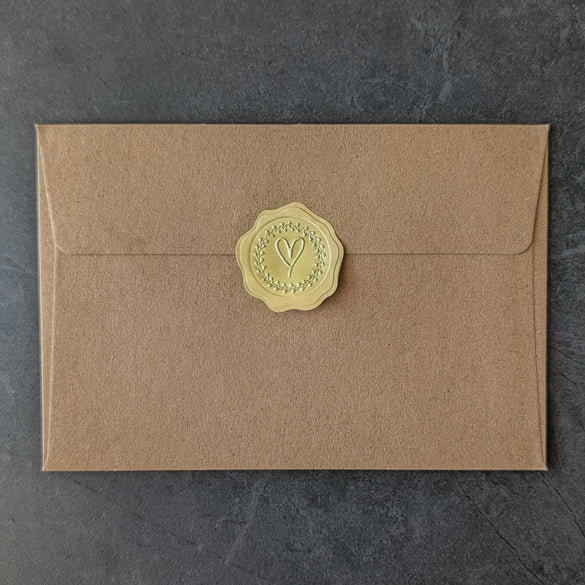 Brown handcrafted envelope from a physical letter with a exclusive golden seal on a dark gray background